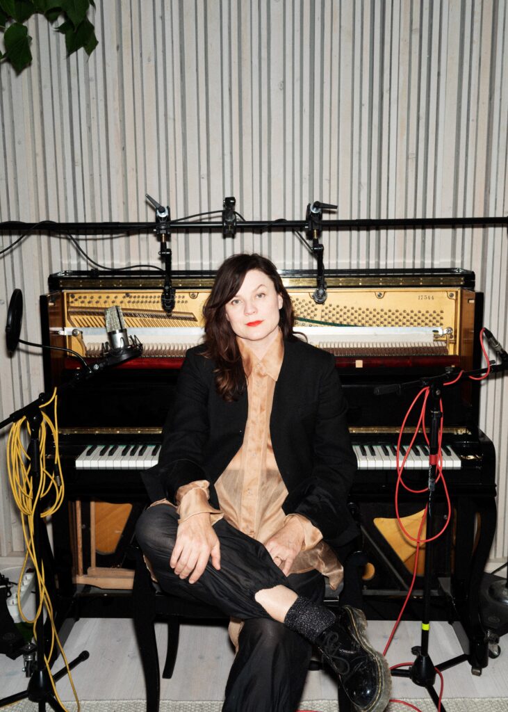 Rebekka Karijord at the piano in her studio